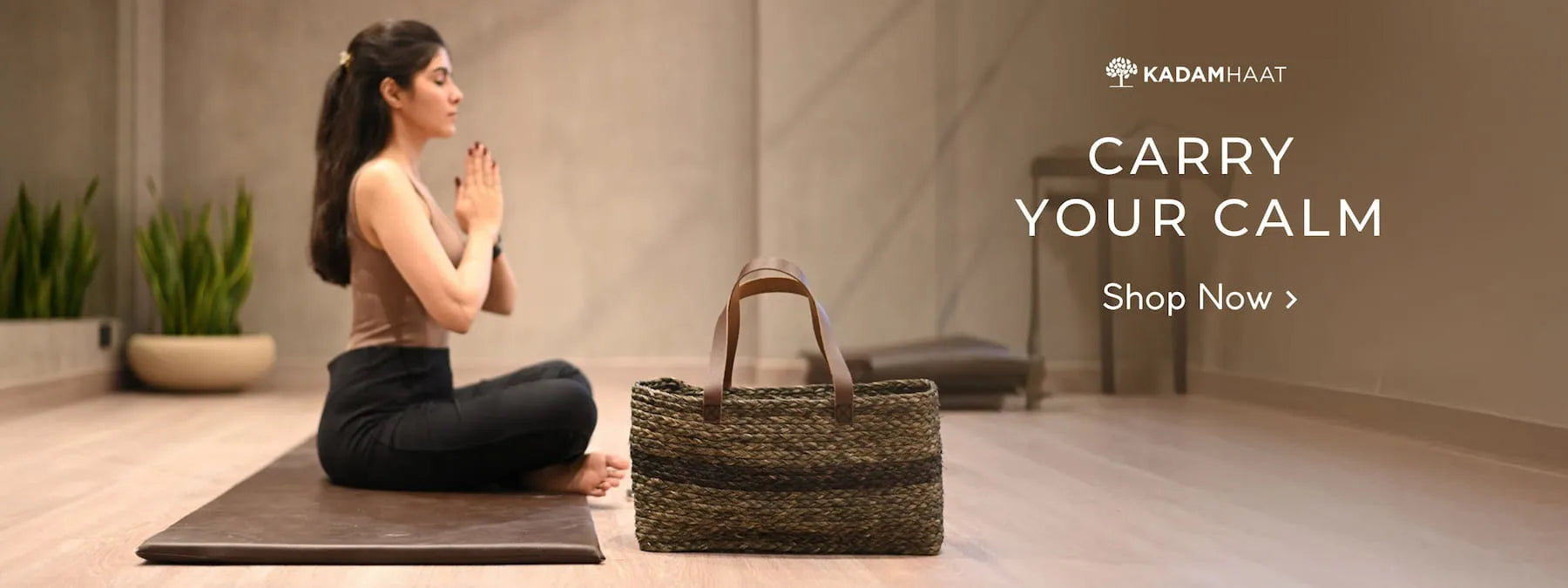 Woman meditating with a woven bag on a mat in a serene setting, featuring Kadam Haat branding.